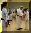 Sensei Herron putting on belt.jpg (30049 bytes)
